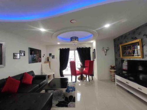 a living room with a couch and red chairs at KANDI Palace, 2-Bedroom serviced Apartment in Angeles