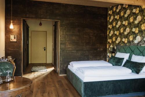 a bedroom with a large bed and a table at Landhaus Engel in Erlaheim