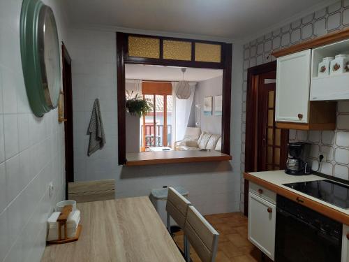 a kitchen with a table and a window in it at apartamento central in Ribadesella