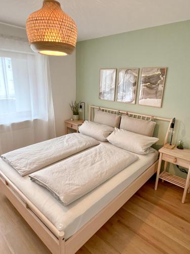 a bedroom with a large bed with white sheets at JUPAS - Premium Apartments Trier in Trier