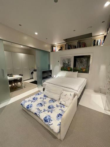 a large bedroom with a large bed and a table at Modern self-contained Ground and Basement studios in London