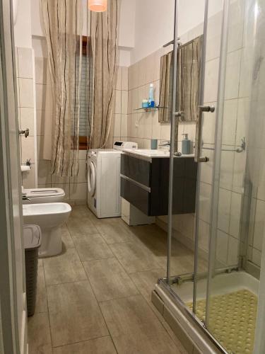 a bathroom with a toilet and a sink and a shower at Casa Valente in Ladispoli