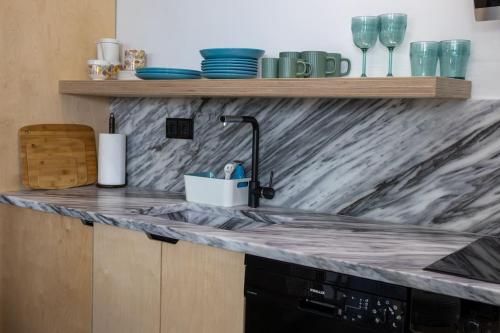 a kitchen counter with a marble counter top at Newwww Kolonaki Split Rock KSR1 in Athens