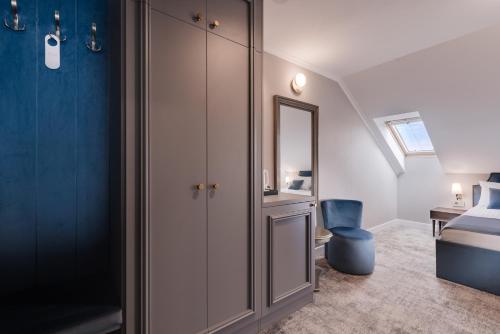 a bedroom with a closet and a bed and a mirror at Hotel Meridian in Cluj-Napoca