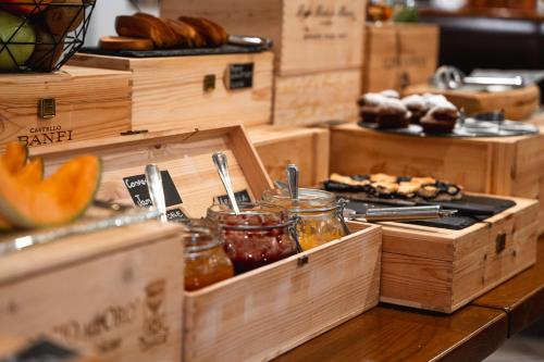 a table with wooden boxes with food on it at Residence Les Coupoles in Champoluc