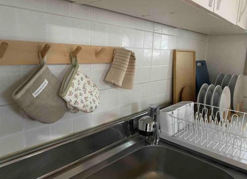 a kitchen counter with a sink and towels on a wall at Stay Mellow in Seoul