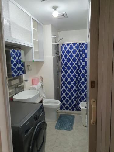 a bathroom with a toilet sink and a shower at Amaia Steps Capitol Central N814 in Bacolod