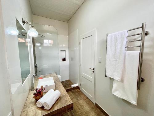 a white bathroom with a sink and a shower at Bella Tilcara Boutique Hotel in Tilcara