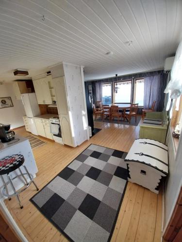 Gula huset في Rottneros: غرفة معيشة مع أريكة وطاولة ومطبخ