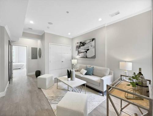 a living room with a couch and a table at Modern Meridian 2 Bedroom (Chapin 3) in Washington, D.C.