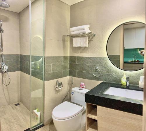 a bathroom with a toilet and a sink and a mirror at Diva B906 - Homestay CITADINES MARINA HA LONG in Ha Long