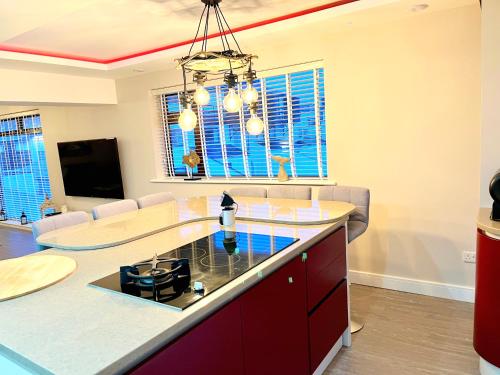 a kitchen with a center island in a living room at Deganwy Beach house 3BR in Deganwy