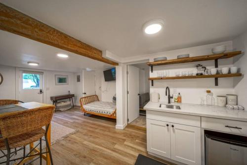 a kitchen and living room with a table and a couch at The Alberta Escape in Portland