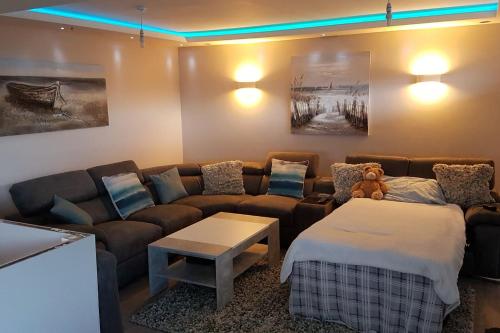 a living room with a couch and a table at Deganwy Beach house 3BR in Deganwy