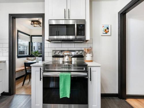 a kitchen with a stove with a tea kettle on it at Picture Perfect Bungalow in the heart of DT Vancouver in Vancouver