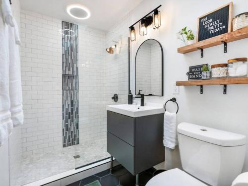 a bathroom with a shower and a sink and a toilet at Picture Perfect Bungalow in the heart of DT Vancouver in Vancouver