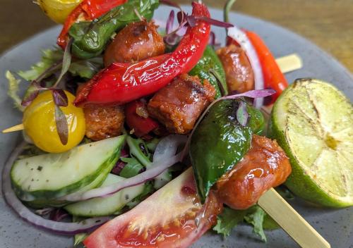 a plate of food with peppers and other vegetables at The Coach House Inn in Chester