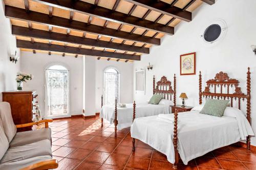 a room with two beds and a couch in it at Villa Juana Blanes in Cala en Blanes