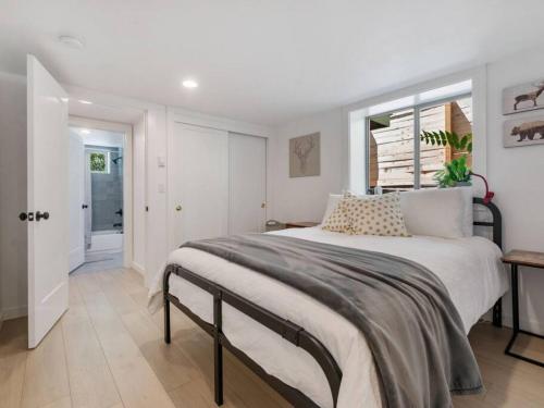a bedroom with a large bed and a window at Renovated Hawthorne Retreat in Portland