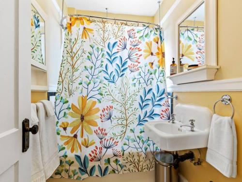a bathroom with a shower curtain with a sink at NW Studio with a View in Portland