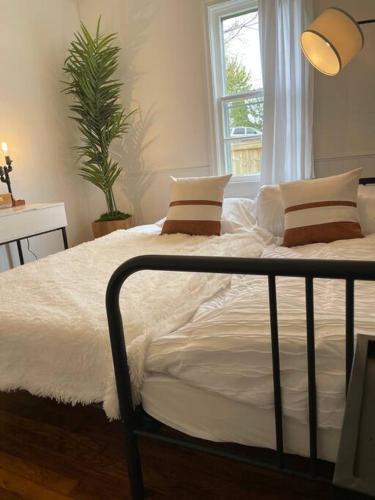 a bedroom with a bed with white sheets and a window at Pet Friendly, 30+ Night Stay in Johnson City