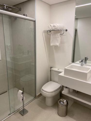 a bathroom with a shower and a toilet and a sink at Flat Hotel in Sao Paulo