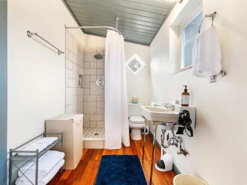 a white bathroom with a sink and a shower at Casa del Sol - Walk to Alberta Arts District in Portland