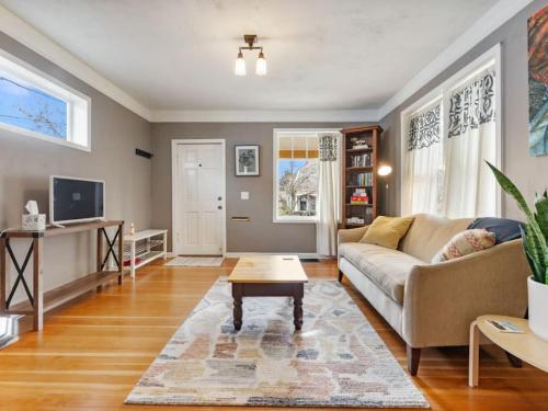 a living room with a couch and a coffee table at Charming 1909 St Johns Bungalow in Portland