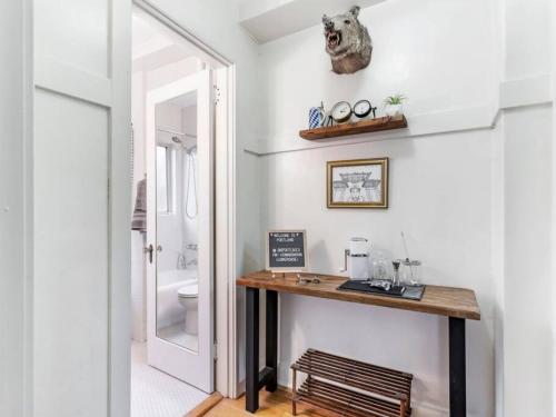 a bathroom with a wooden table and a toilet at Central Downtown Studio with Vintage Charm near Train in Portland