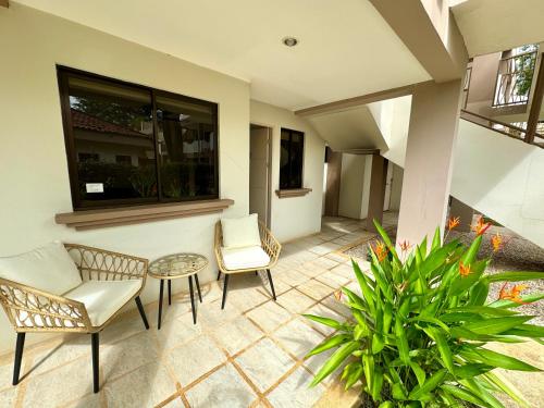 a patio with two chairs and a table at Coco Boho Beach Condo in Coco