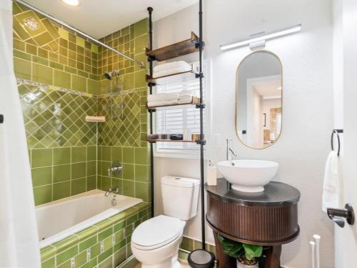 a bathroom with a sink and a toilet and a tub at The Auric Door Inn on N Mississippi in Portland