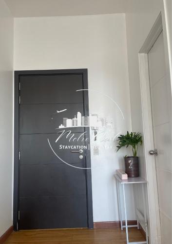 a black door with a city on it at MetroNest Sutherland in Manila