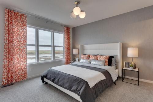 a bedroom with a large bed and a large window at Spacious Modern Home With King Bed & Office in Calgary