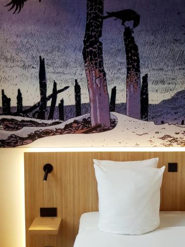 a picture of a bedroom with a bed and a painting at Comic Art Hotel in Ghent
