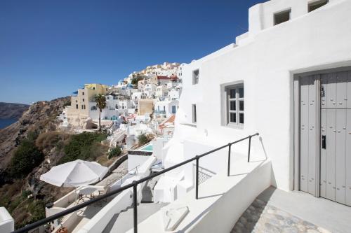 a view of the city from the balcony of a house at Ducato di Oia - Adults Only in Oia