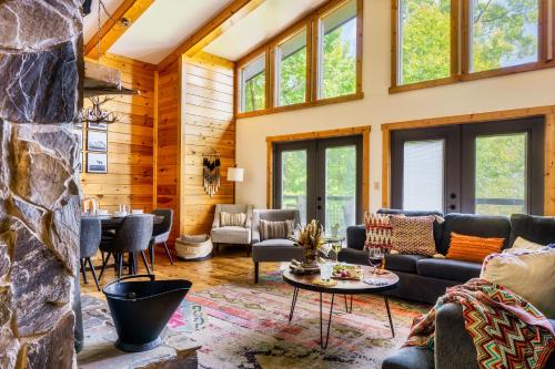 a living room with a stone wall at Woodhaven - Private - 3 Suites - Gorgeous Views - 3 Pools - GameRm - HotTub - Lots of Bears in Gatlinburg