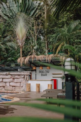 a building with benches and a sign that reads ball out bat at The Vatika Resort and Spa in Ao Nang Beach
