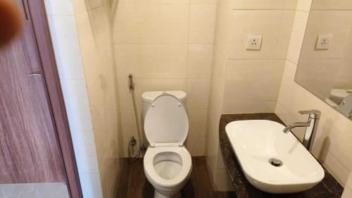 a small bathroom with a toilet and a sink at SleepRest @ NTC in Nagoya