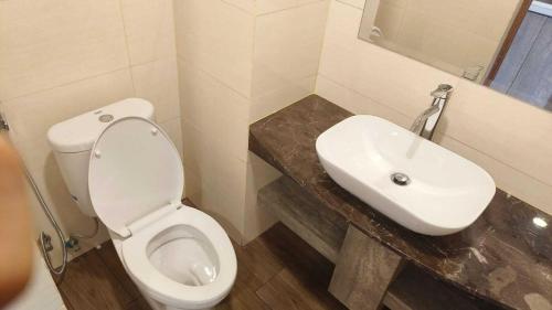 a bathroom with a white toilet and a sink at SleepRest @ NTC in Nagoya