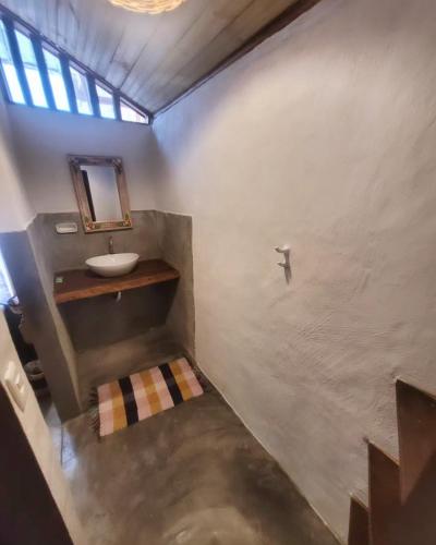 a bathroom with a sink and a mirror at Pousada Raiz Forte in Caraíva