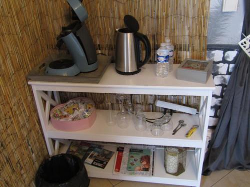a white shelf with a coffee maker on it at Chambre d'hôtes Au Nid du Thil in Beauvais