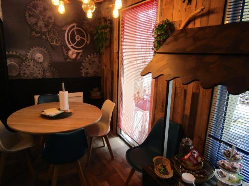 a dining room with a table and chairs and a candle at Chambre d'hôtes Au Nid du Thil in Beauvais