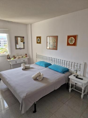 a bedroom with two beds with blue pillows at Eldorado Emily 1 Bedroom Sea view in Playa de las Americas