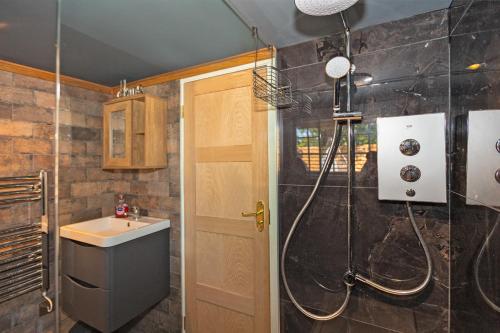 a bathroom with a shower and a sink at Finest Retreats - Roxton Roost in Potton