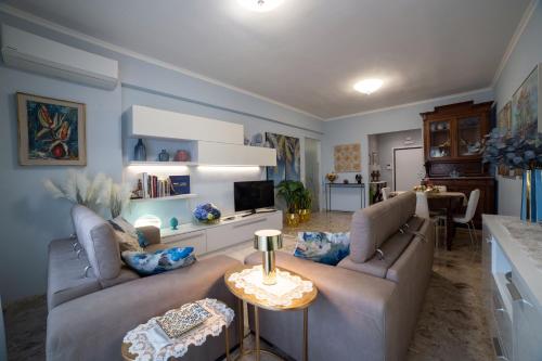 a living room with two couches and a table at Dimora Giulia in Campobasso