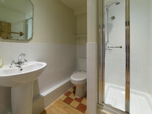 a bathroom with a sink and a toilet and a shower at Pail End in Brassington