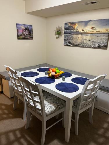 a dining room table with a bowl of fruit on it at Cozy private getaway. Close to Convention Center and Medical Centers in Monroeville