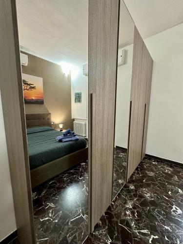 a bedroom with a bed and a mirror at Casavacanzetoffee Gold in Bologna