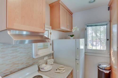 a kitchen with a white refrigerator and a window at Colton Studio with Fire Pit, 4 Mi to San Bernardino! in Colton