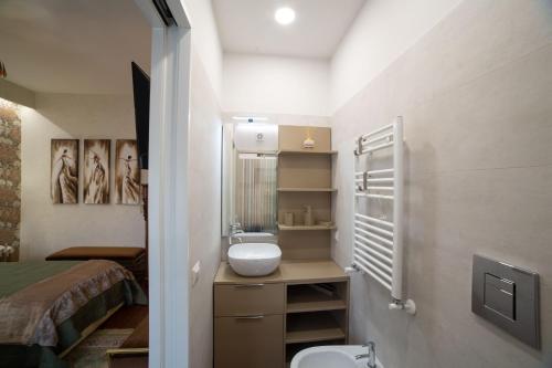 a small bathroom with a sink and a toilet at Dimora Giulia in Campobasso